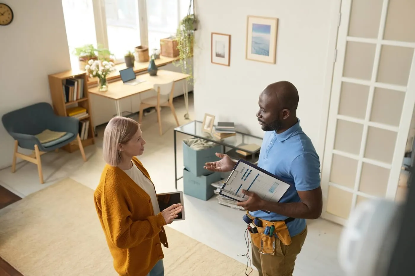 Woman having a chat with a service professional inside a home