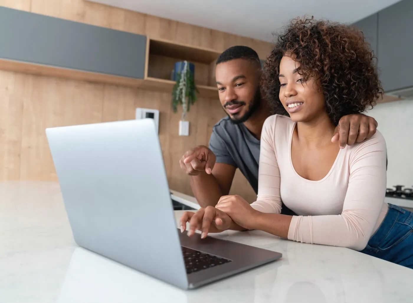 Young couple using a laptop together at home