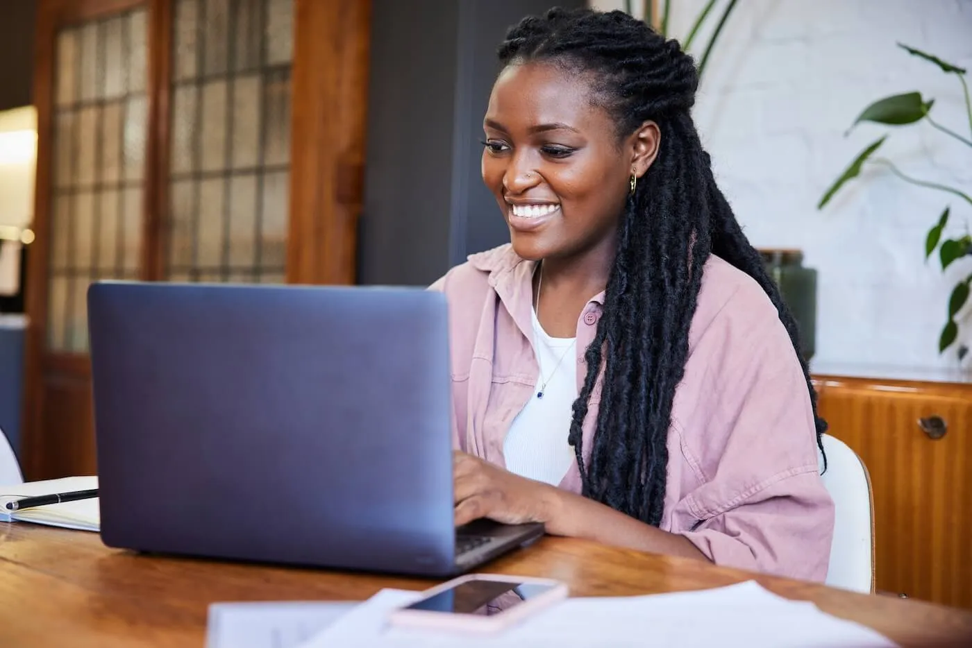 Smiling young woman working on her laptop