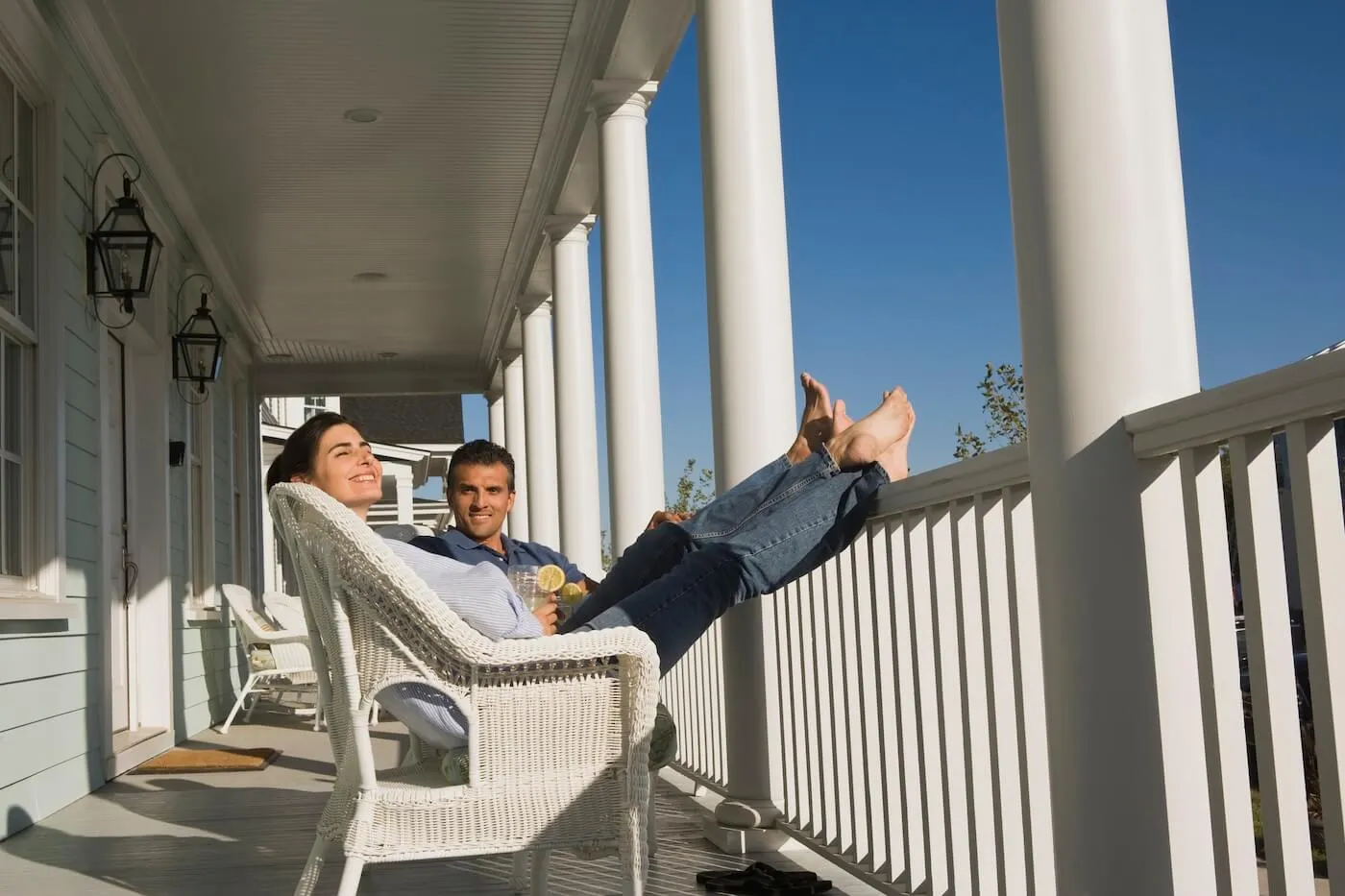 Relaxed couple enjoying a sunny day on a front porch