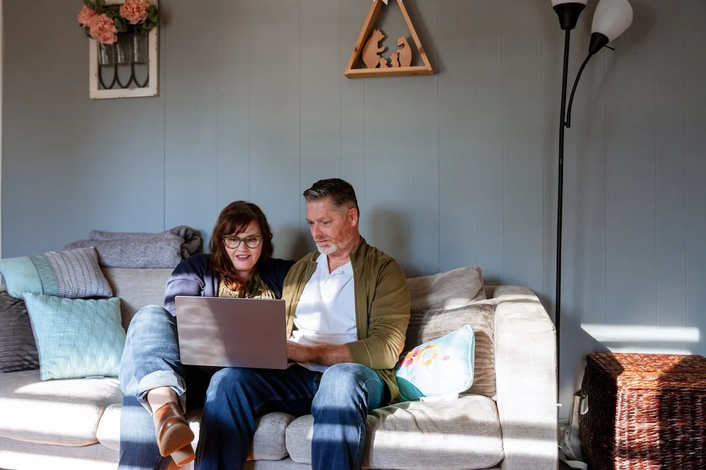 A matur couple using their laptop at home