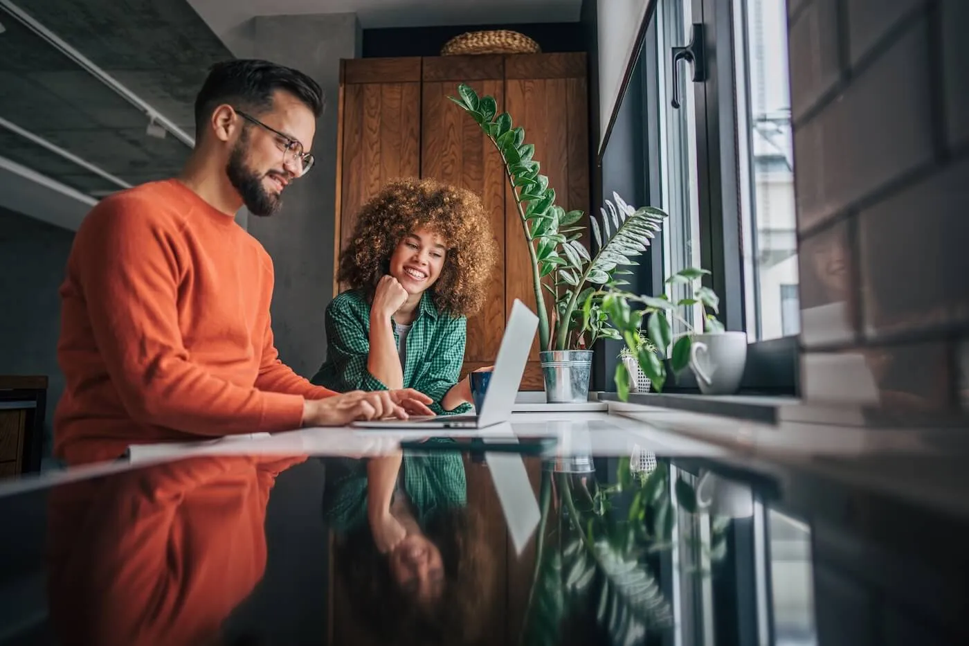 Happy couple using a laptop together