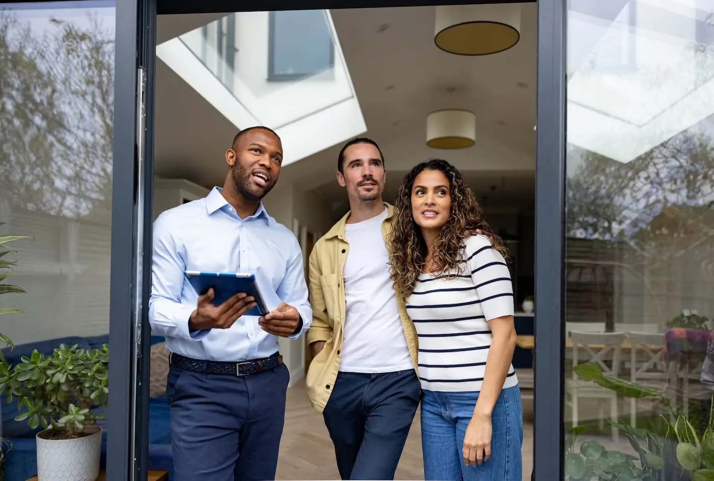 A real estate agent showing a house to the prospective buyers