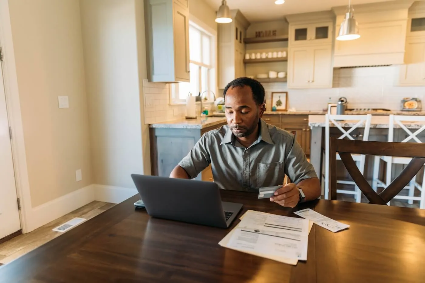 Focused man filing taxes at home