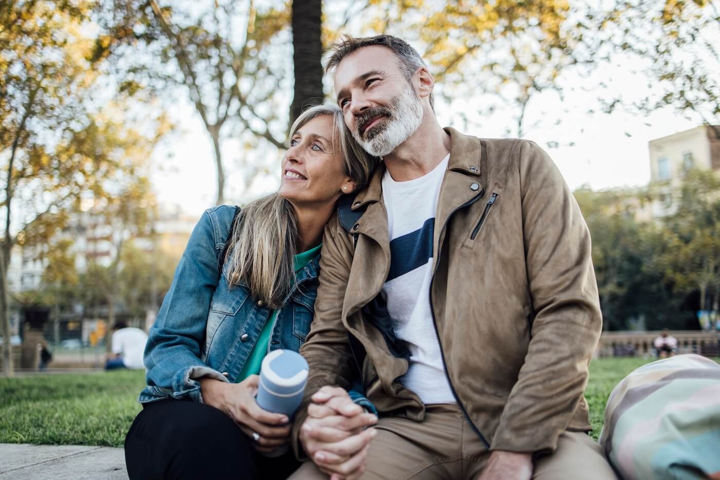 A mature couple enjoying a peaceful fall afternoon in the park