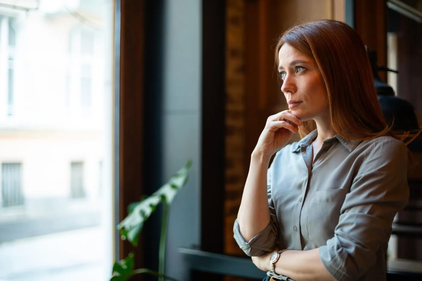 Pensive woman looking at the window