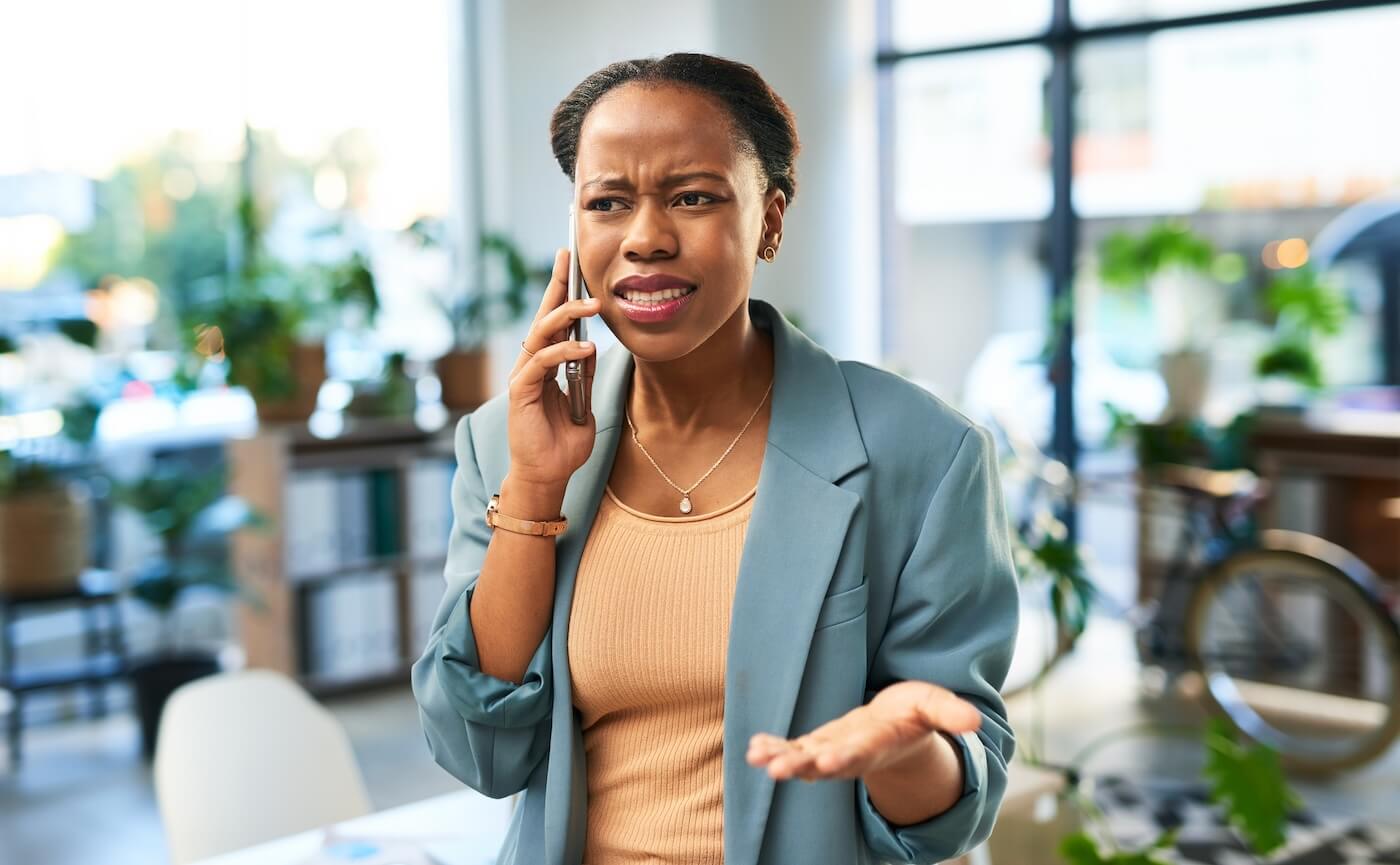 Concerned businesswoman making a phone call in the cafe