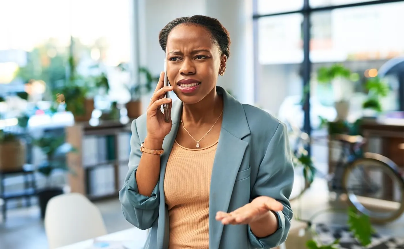 Concerned businesswoman making a phone call in the cafe
