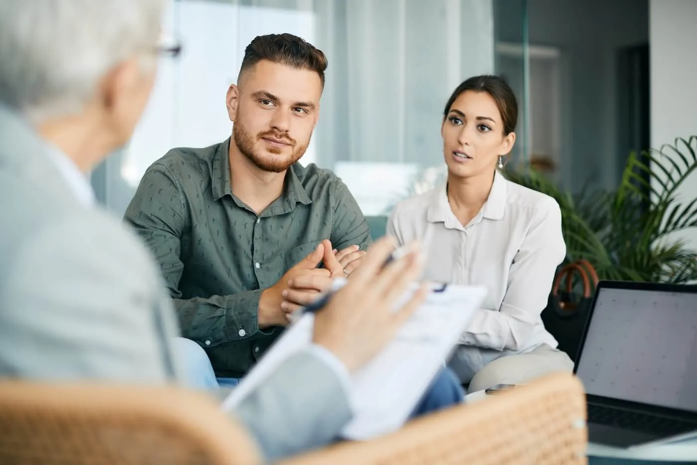 Young couple having a meeting with their financial advisor in the office