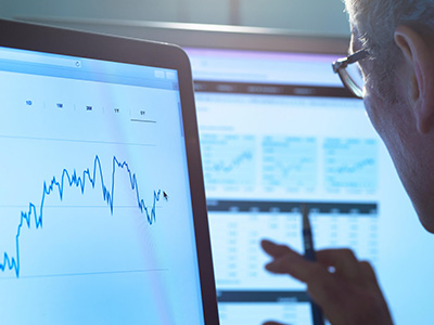 a man looking at a computer screen displaying data visualizations.