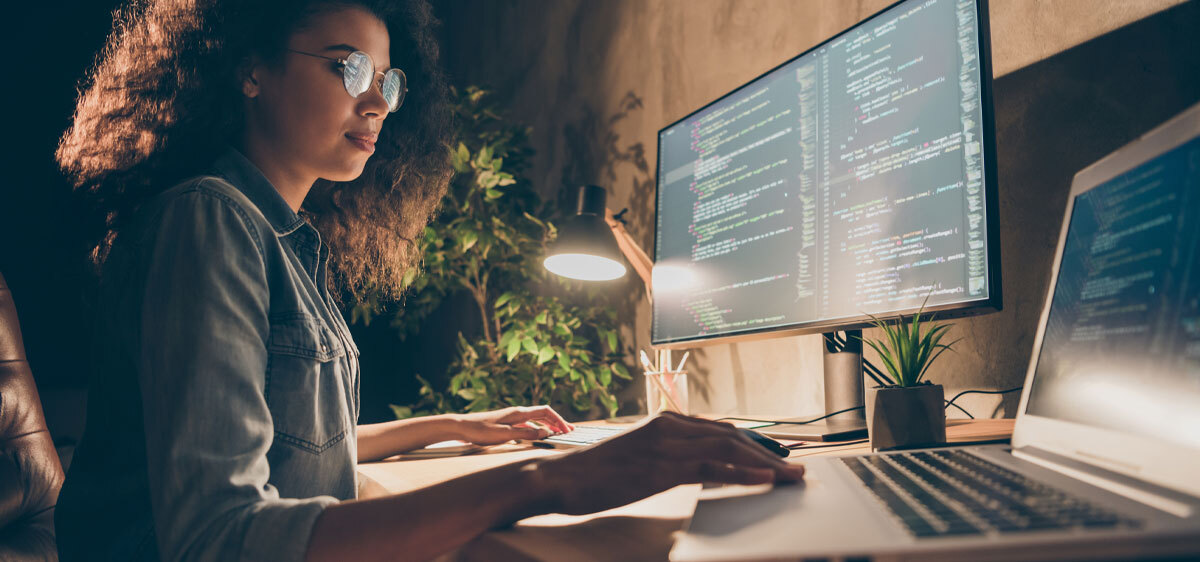 woman working on laptop and screen