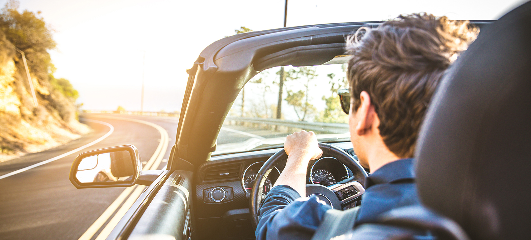 man driving in convertible