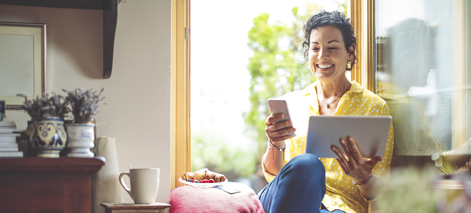 Woman shopping online using tablet and mobile phone