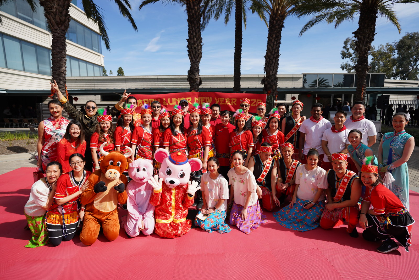 Experian's Asian American ERG in traditional clothing, posing together with Year of the Rat mascot