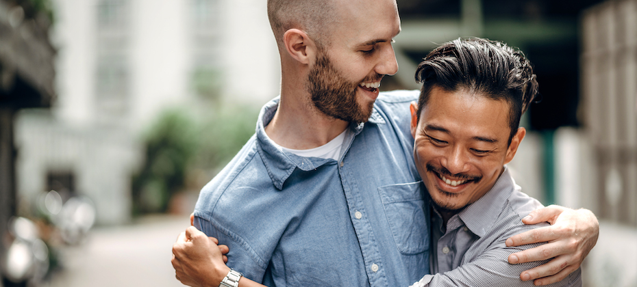 Gay couple walking outdoors on city street