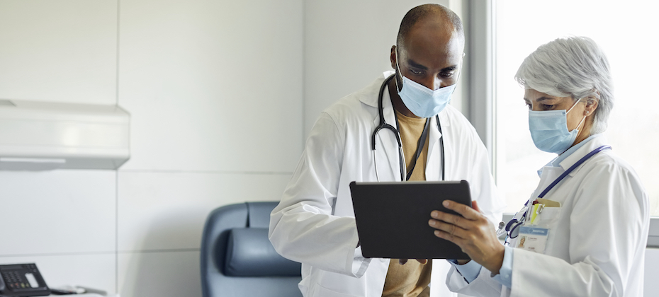 Healthcare workers wearing face mask discussing in hospital