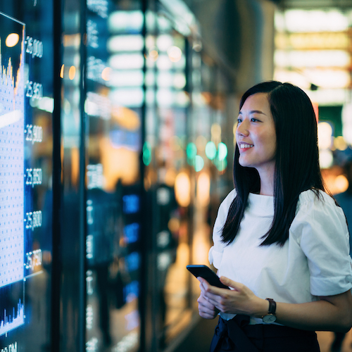 Young Asian businesswoman checking data.