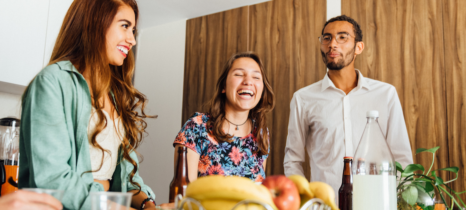 Three young friends laughing together