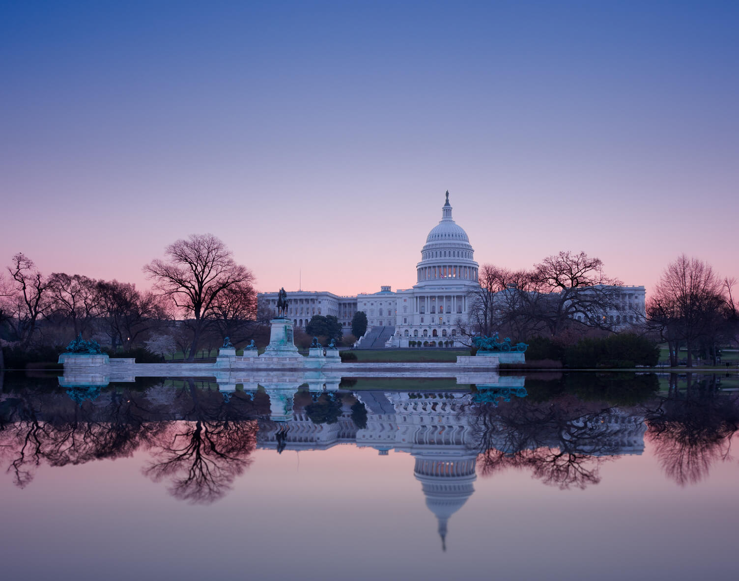 Experian Employer Services graphic showing the U.S. Capitol building at sunset with text reading Q1 Alerts: Workforce Compliance & Legislative Updates on a purple and blue gradient background.