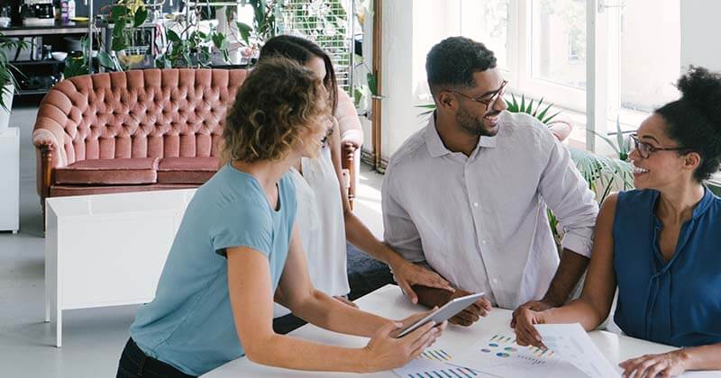 Four-coworkers-collaborating-at-table