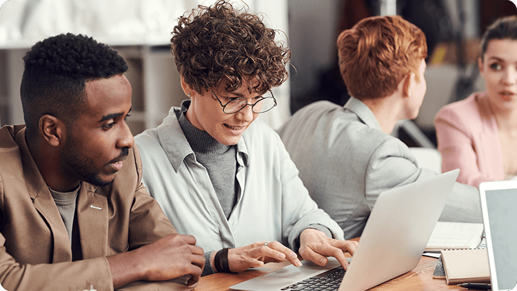 two people working on laptop