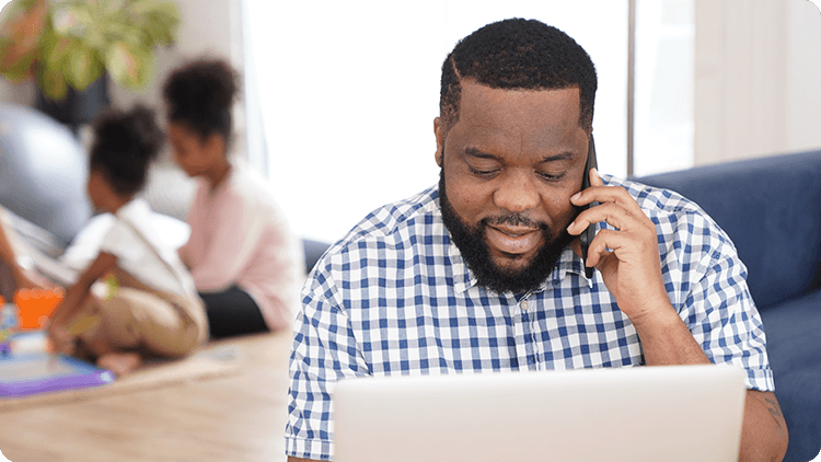 man on laptop and phone