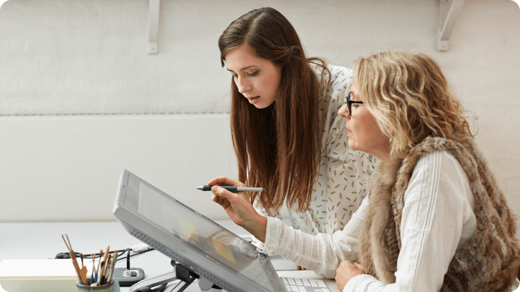 two women looking at screen