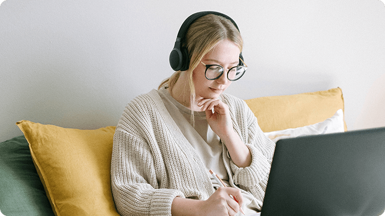 woman on laptop with headphones