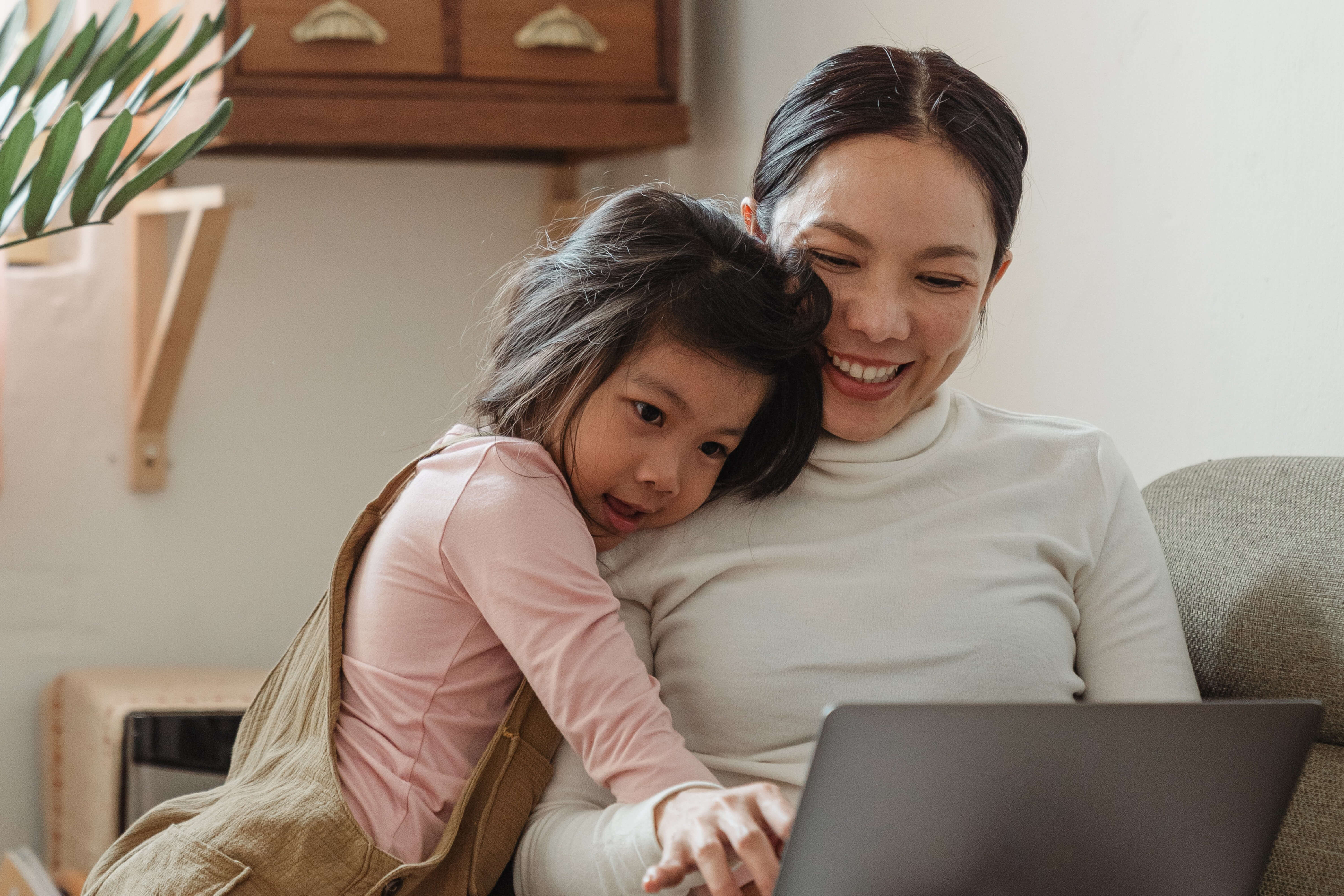 two people smiling at laptop