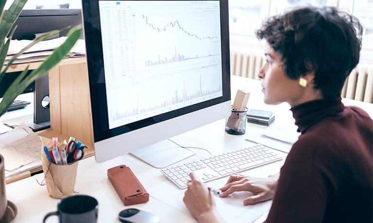 Woman looking at analytics on computer screen