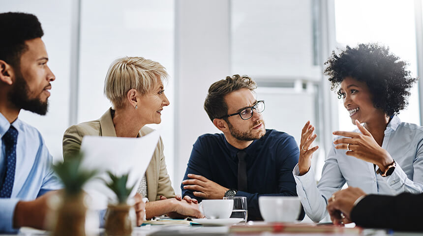 Four business people in meeting room