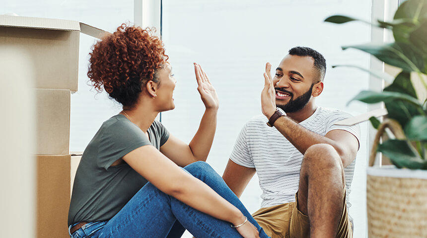 young couple celebrating in new home