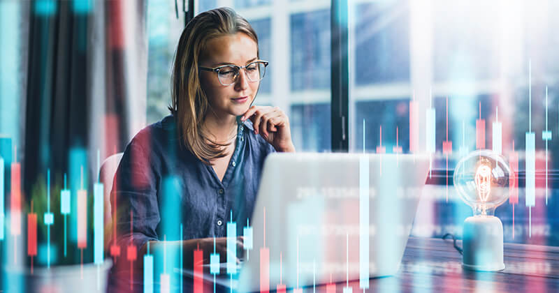 Woman looking at abstract graph on screen