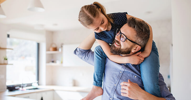 Father and daughter playing in kitchen