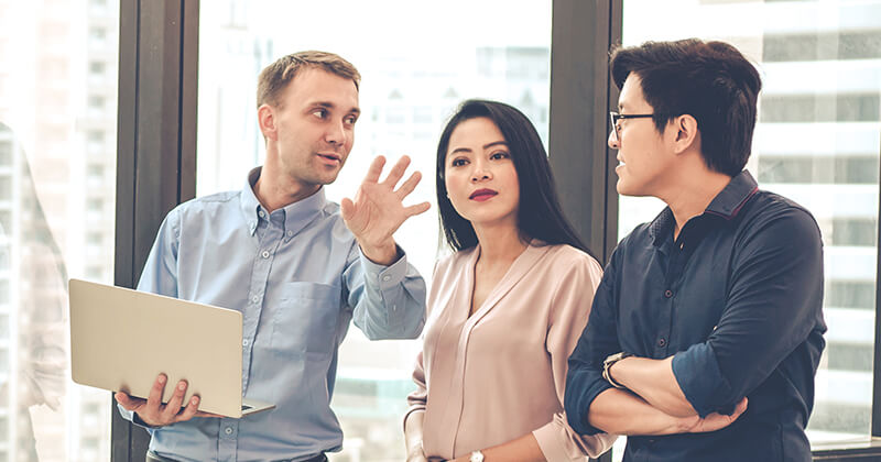 Man talking to customers in office