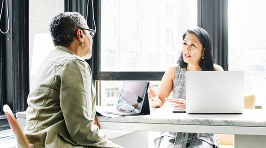 Business discussion with laptops open