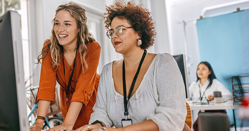 woman collegues working together on computer