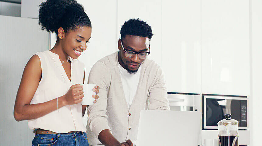 Couple looking laptop at home