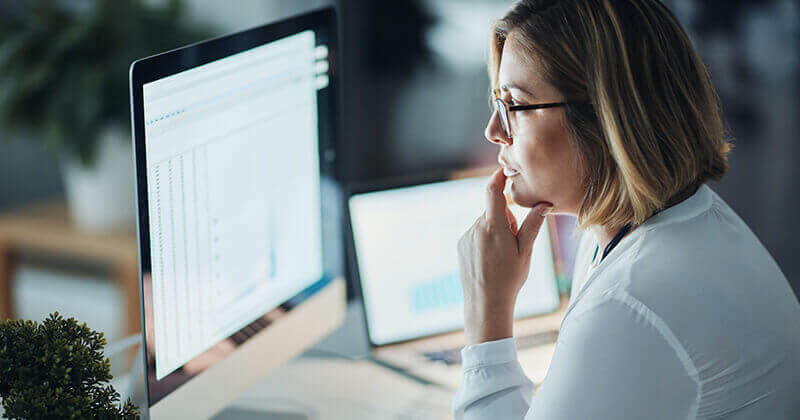 Woman looking at abstract graph on screen