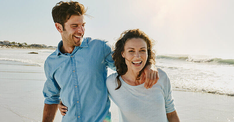 Laughing couple on the beach