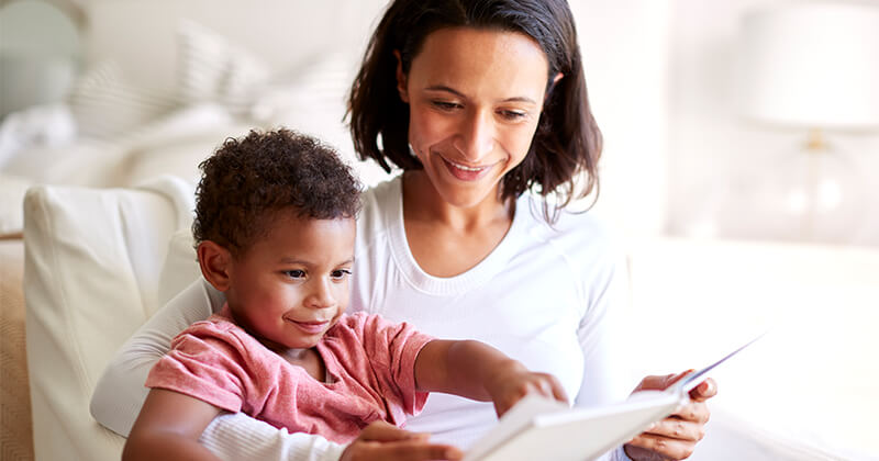  mother-sitting-reading-book-son