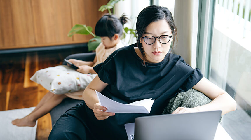 Mother working from home with at table with daughter