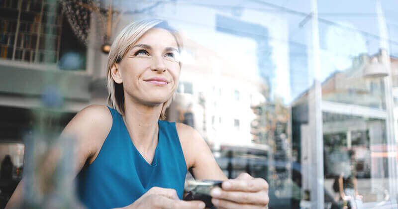 Woman holding credit card and smiling