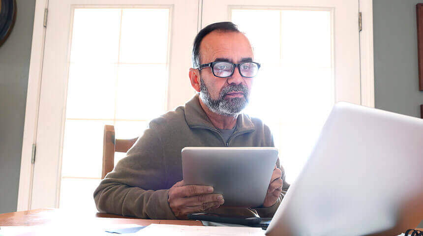 Person on tablet and laptop