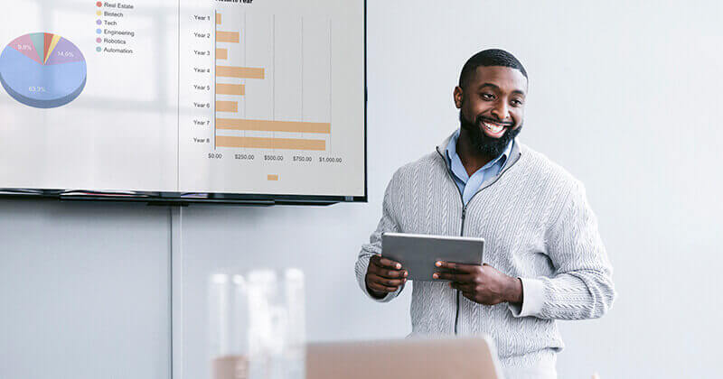 Smiling businessman holding tablet