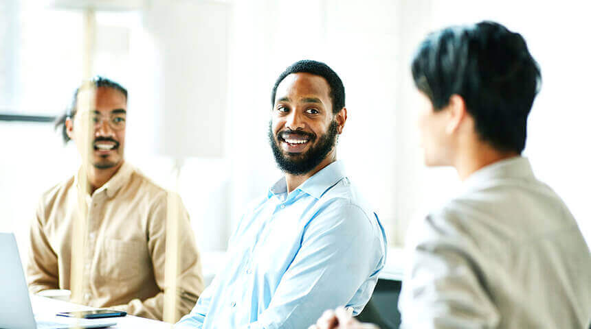 Three men smiling business discussion