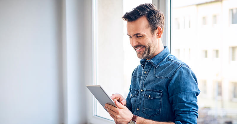 man looking at tablet