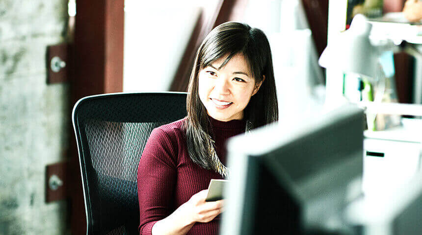 Woman smiling and reading project brief