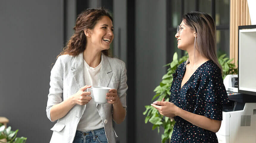 Two people discussing business in a common area