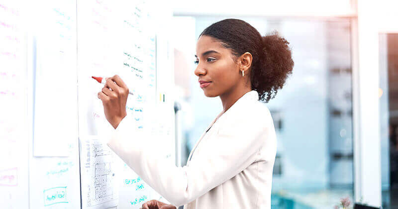 Woman writing on whiteboard